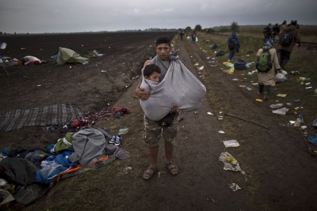 refugee carying his cousin